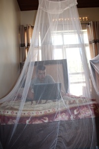 Darren at his Rwandan office preparing his video editing.