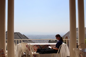 Suzy pondering on the veranda overlooking the city of Kigali.